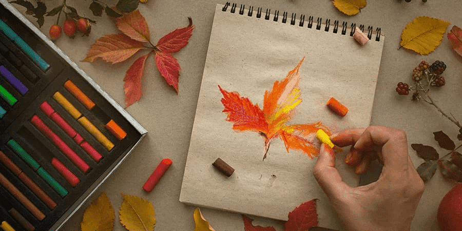 Profesional creativo dibujando una hoja de otoño con colores pastel